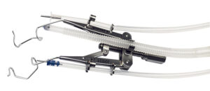 Adjustable speculum with supports for silicone tubes infusion lines and fiber optic