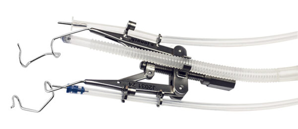 Adjustable speculum with supports for silicone tubes infusion lines and fiber optic